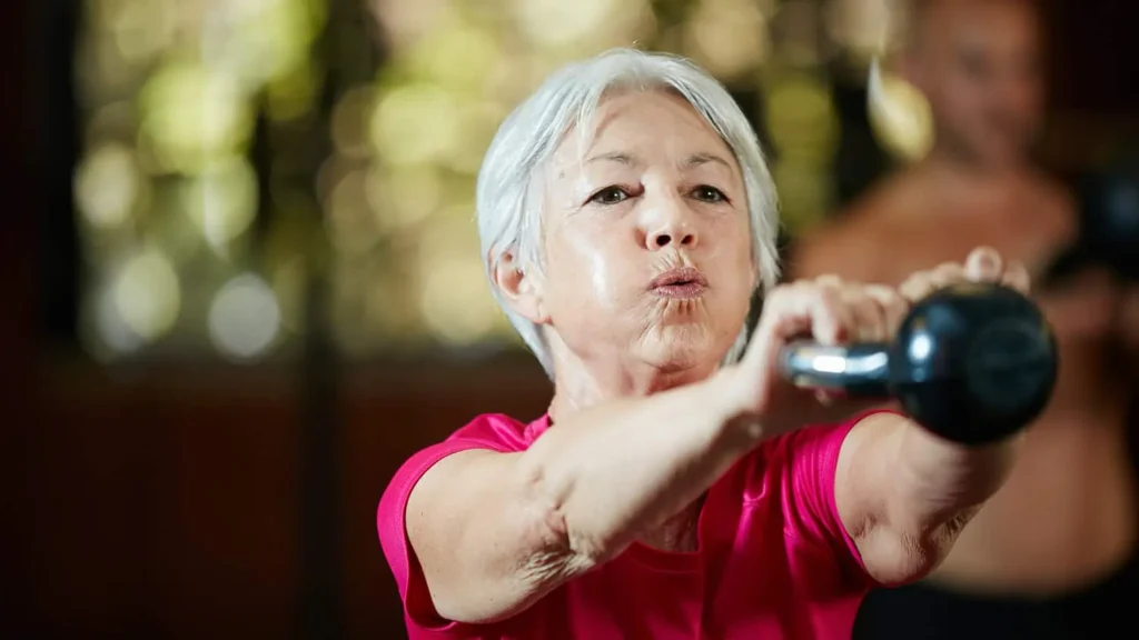 Toning Arms Without the Bulk: Is It Achievable? 1 Woman doing resistance band exercises for toned arms Stowmarket