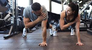 Sculpting Sleek Arms: The Essential Role of Cardio in Toning Without Bulking Up 1 Image of man and woman doing Cardio Stowmarket to tone their arms.